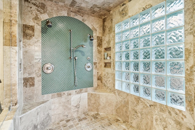 bathroom with plenty of natural light and a tile shower