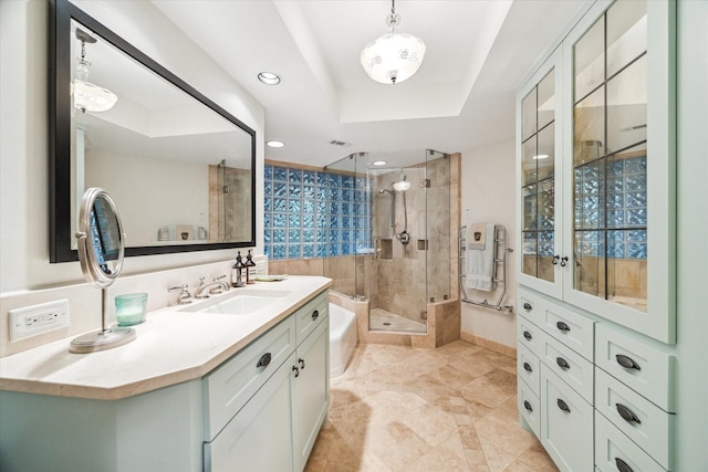 full bathroom featuring a tray ceiling, recessed lighting, visible vents, a stall shower, and vanity