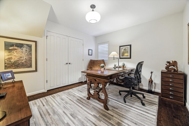 office space with wood finished floors and baseboards