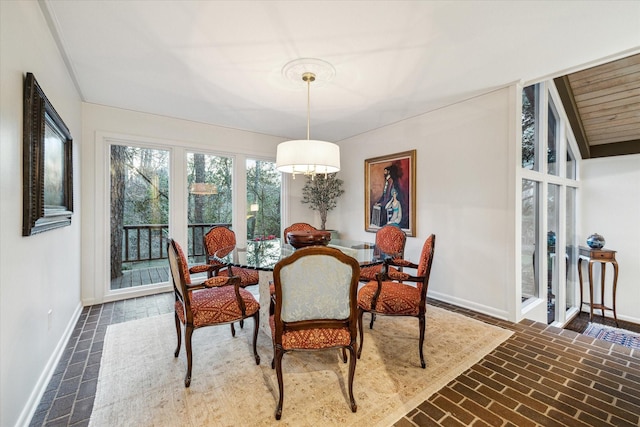 dining room with brick floor and baseboards