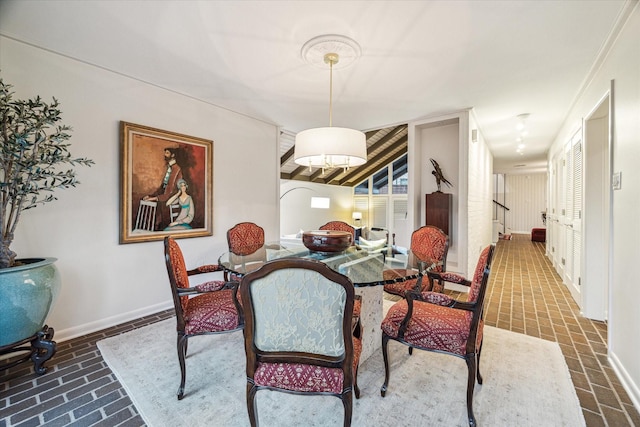 dining area featuring stairway and baseboards