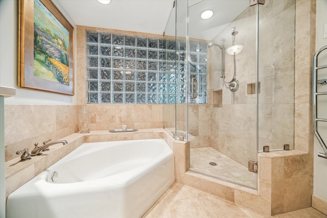 bathroom with tile patterned flooring, a shower stall, a bath, and recessed lighting