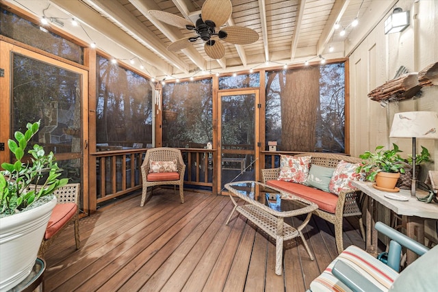 sunroom featuring wooden ceiling, beam ceiling, and a ceiling fan