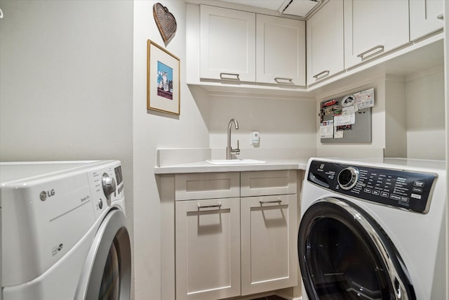 laundry room featuring cabinet space, washing machine and dryer, and a sink