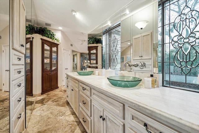 bathroom with double vanity, a sink, and visible vents