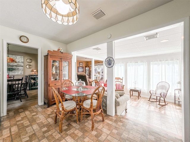 dining room featuring visible vents and baseboards