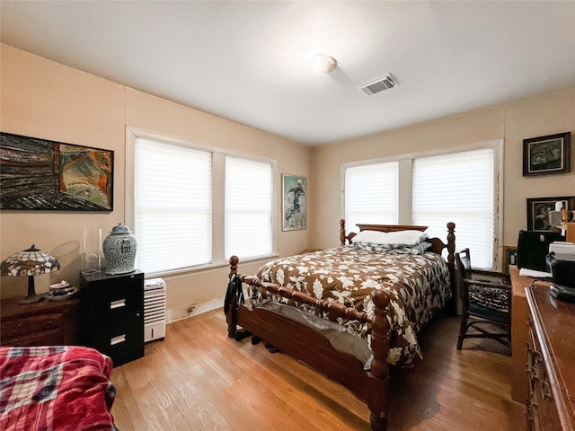 bedroom featuring light wood-style flooring and visible vents