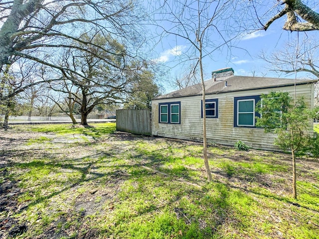 view of side of property featuring fence