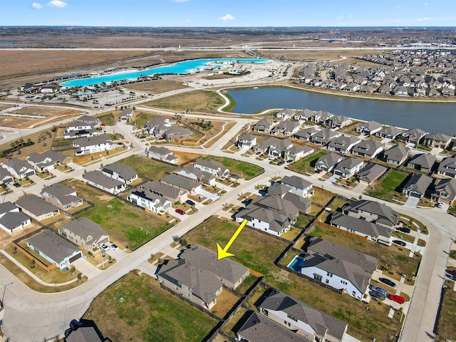 birds eye view of property with a water view and a residential view