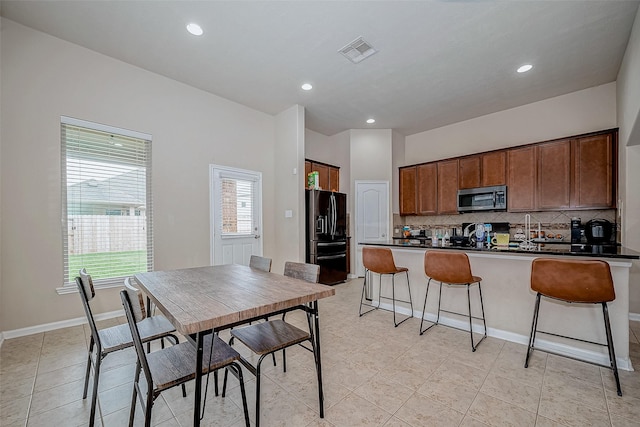 dining room featuring baseboards, visible vents, and recessed lighting