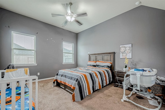 bedroom with vaulted ceiling, ceiling fan, baseboards, and light colored carpet