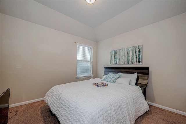 carpeted bedroom with baseboards and vaulted ceiling