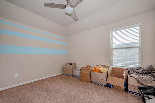 interior space with a ceiling fan, carpet flooring, and baseboards