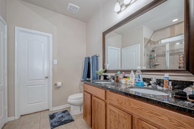 bathroom with a stall shower, a sink, visible vents, and tile patterned floors