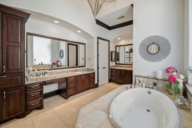 bathroom featuring visible vents, ornamental molding, tile patterned floors, a whirlpool tub, and vanity