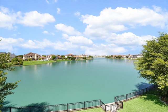 property view of water with a residential view and fence