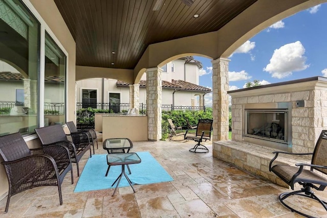 view of patio / terrace with an outdoor stone fireplace