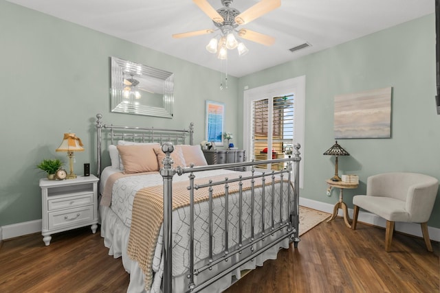 bedroom with baseboards, visible vents, ceiling fan, and wood finished floors