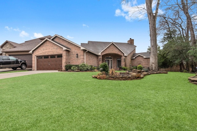 view of front of property with a garage, brick siding, driveway, a front lawn, and a chimney