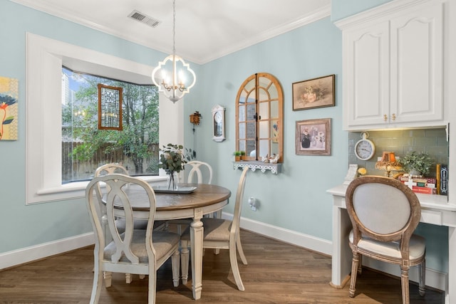 dining space with dark wood-type flooring, visible vents, baseboards, ornamental molding, and an inviting chandelier