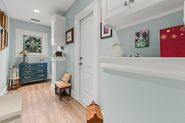 interior space featuring recessed lighting, light wood-type flooring, visible vents, and baseboards