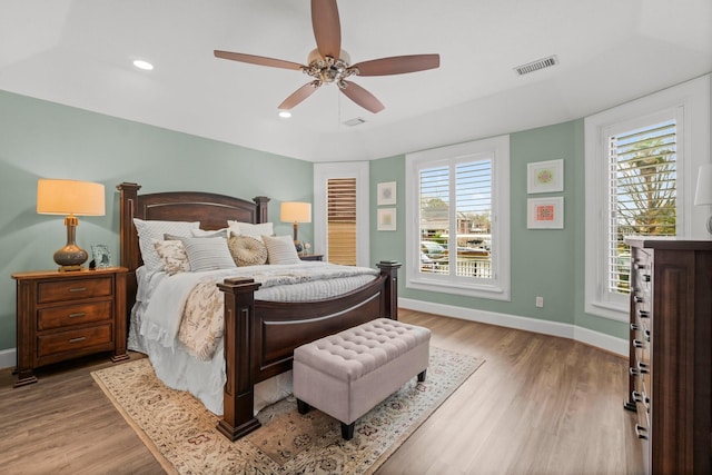 bedroom featuring recessed lighting, wood finished floors, visible vents, and baseboards