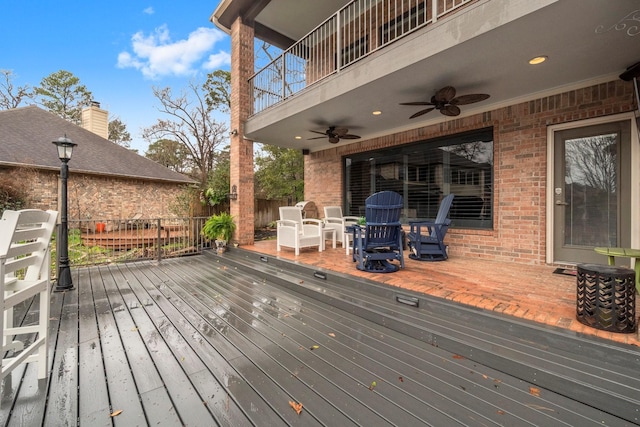 wooden terrace with fence and a ceiling fan