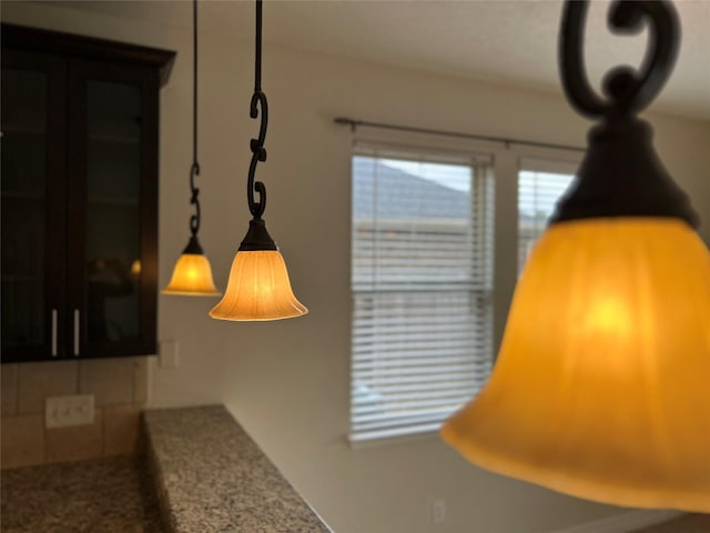 interior details featuring stone countertops and decorative light fixtures