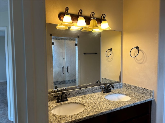 full bathroom with a sink, a shower stall, and double vanity