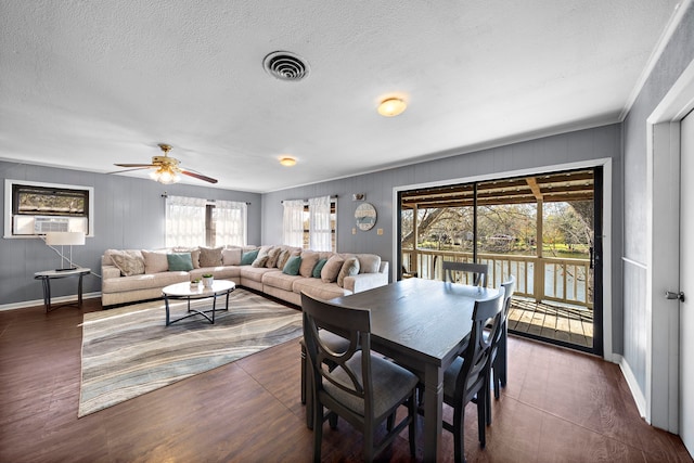 dining space featuring visible vents, a ceiling fan, a textured ceiling, wood finished floors, and baseboards