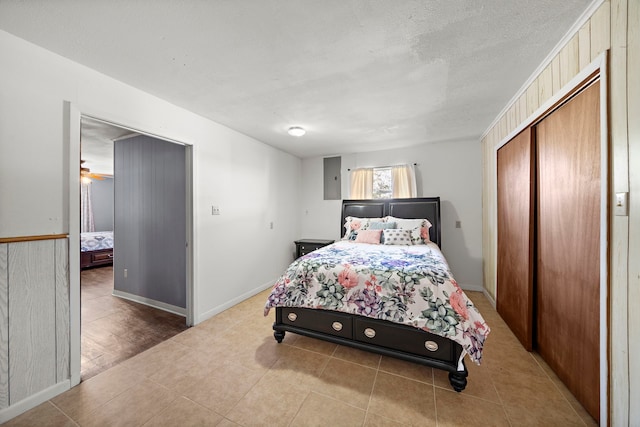 bedroom with a closet, a textured ceiling, and baseboards