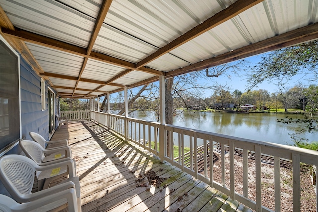 wooden terrace featuring a water view