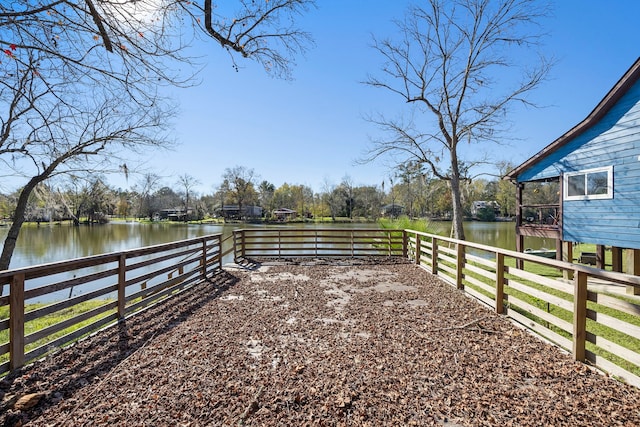 view of yard with a water view and fence