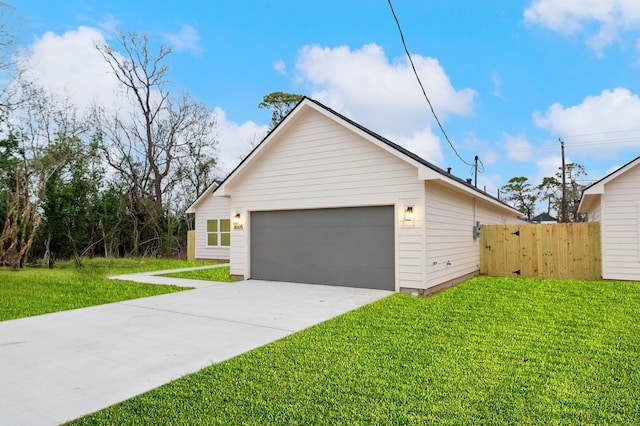 view of home's exterior with a garage, a lawn, and fence