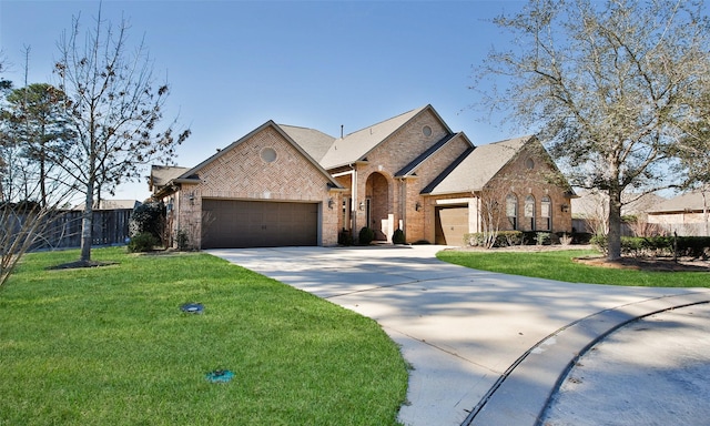 view of front of house with brick siding, an attached garage, fence, driveway, and a front lawn