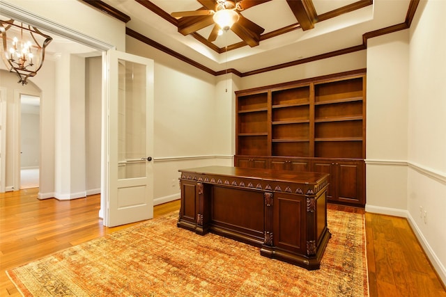 unfurnished office featuring crown molding, ceiling fan with notable chandelier, baseboards, and light wood-style floors