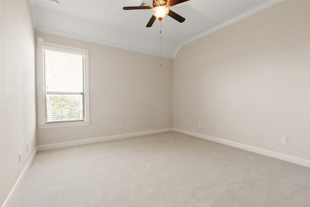 unfurnished room featuring light carpet, ceiling fan, baseboards, and crown molding