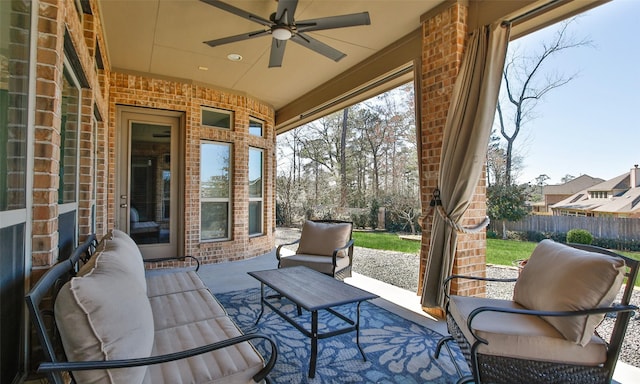 view of patio featuring ceiling fan, outdoor lounge area, and fence