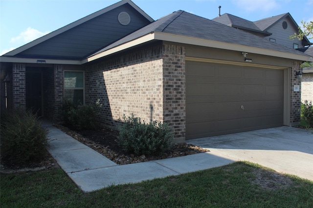 view of property exterior featuring concrete driveway, brick siding, and an attached garage