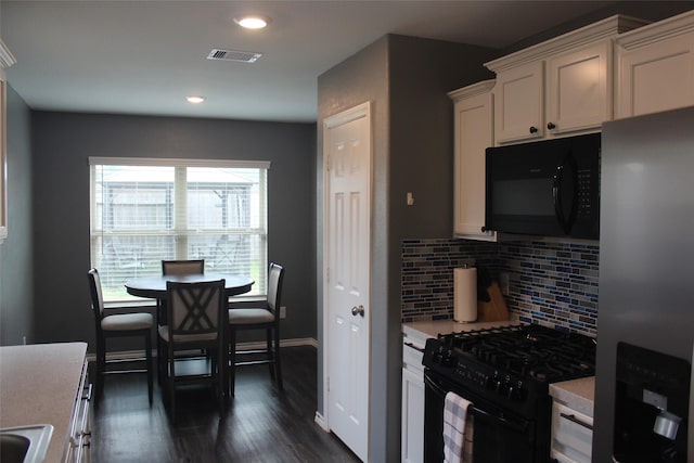 kitchen with visible vents, white cabinets, light countertops, black appliances, and tasteful backsplash