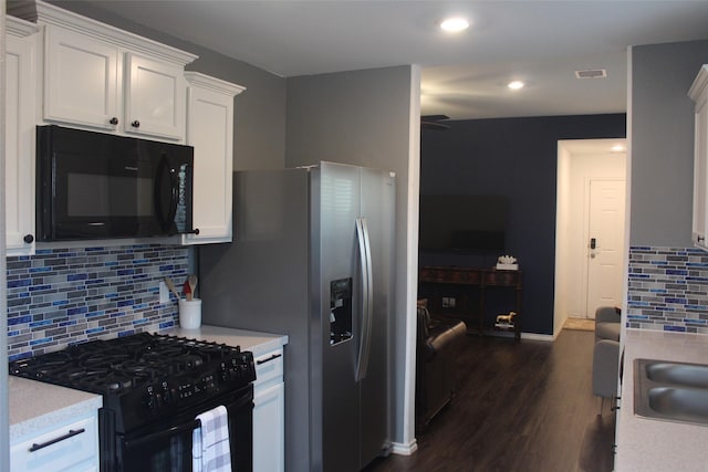 kitchen featuring visible vents, dark wood-style floors, light countertops, black appliances, and white cabinetry