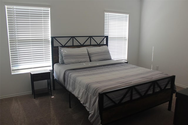 bedroom featuring carpet floors and baseboards