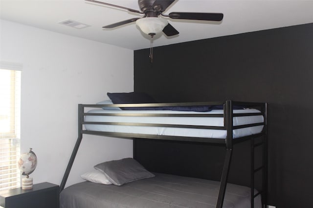 bedroom featuring ceiling fan and visible vents