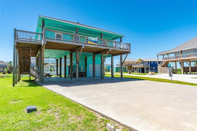 view of property's community with a carport, a yard, stairway, and driveway