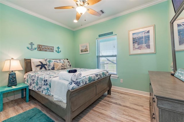 bedroom with light wood finished floors, visible vents, baseboards, ceiling fan, and crown molding