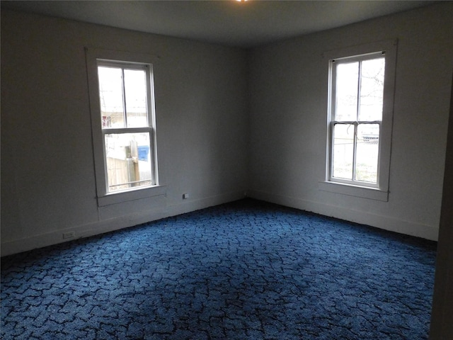 carpeted spare room with baseboards