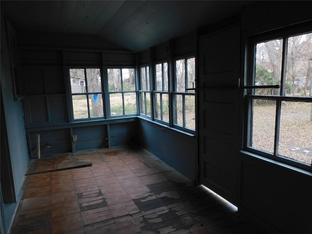 unfurnished sunroom with lofted ceiling