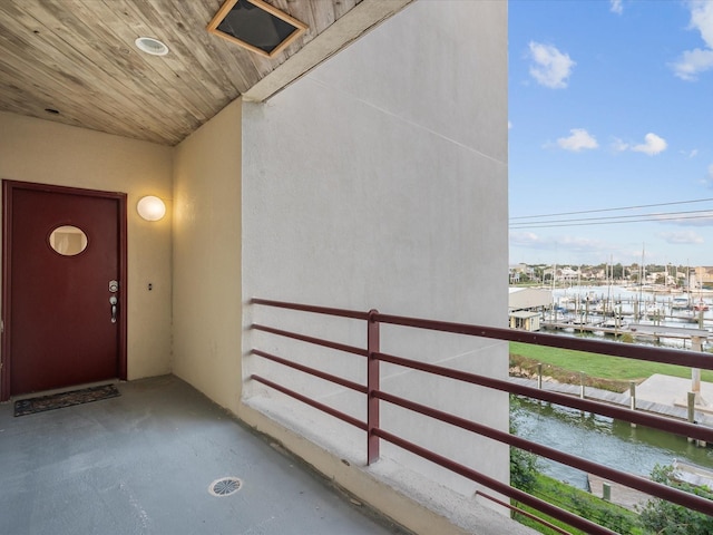 doorway to property featuring a water view and a balcony