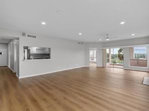 unfurnished living room with visible vents, baseboards, wood finished floors, and recessed lighting