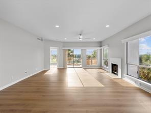 unfurnished living room featuring a fireplace, a wealth of natural light, and wood finished floors